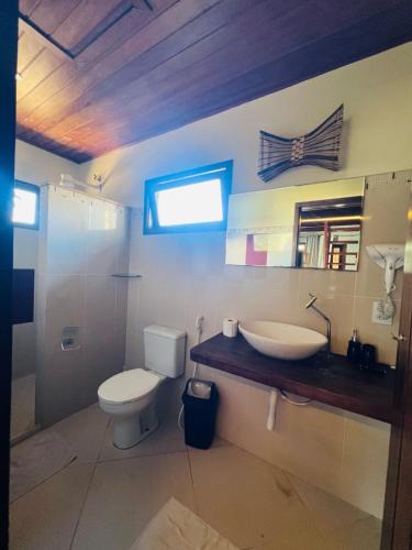 a bathroom with a toilet and a sink at Vila Do Pescador in Barra Grande