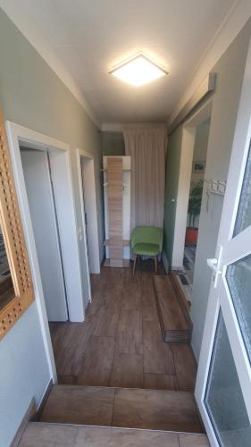 a hallway with a green chair in a room at Ferienwohnung Stein in Sassnitz