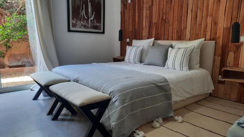 a bedroom with a large bed with a window at Villa Roseaux heated pool Marrakech in Najem
