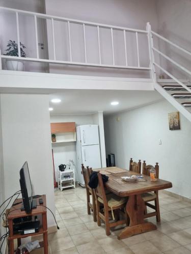a dining room with a table and a loft at Renacer in Playa Unión
