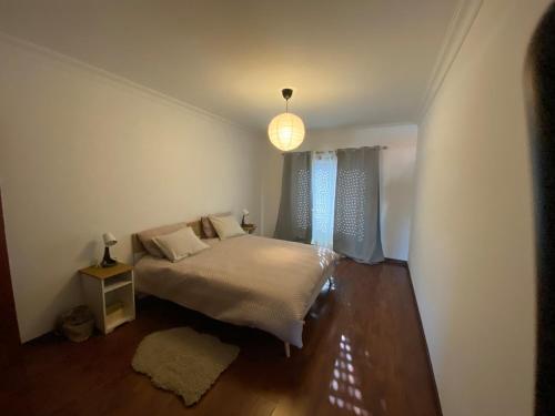 a small bedroom with a bed and a window at Sweet home in Entroncamento