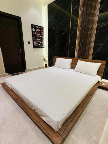 a large white bed in a room at Anayah Fam Rental in Rawalpindi