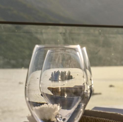 a glass of wine with a view of a city at Santa Boka in Perast