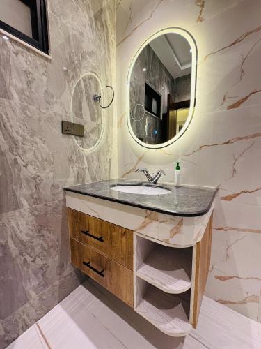 a bathroom with a sink and a mirror at Anayah Fam Rental in Rawalpindi