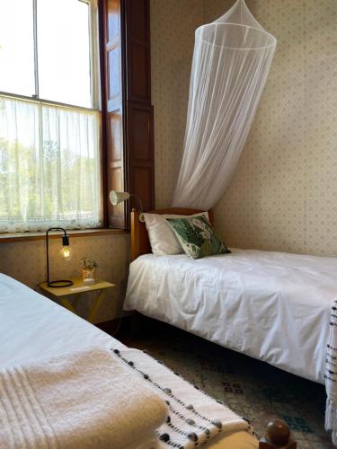 a bedroom with two beds and a window at Albert Manor guest house in Ladismith