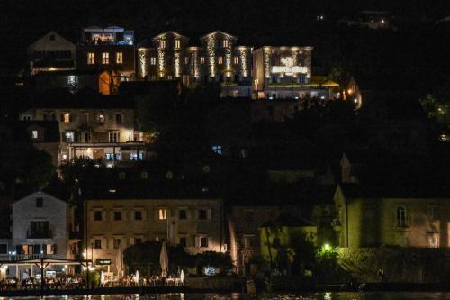 a view of a city at night with lights at Santa Boka in Perast