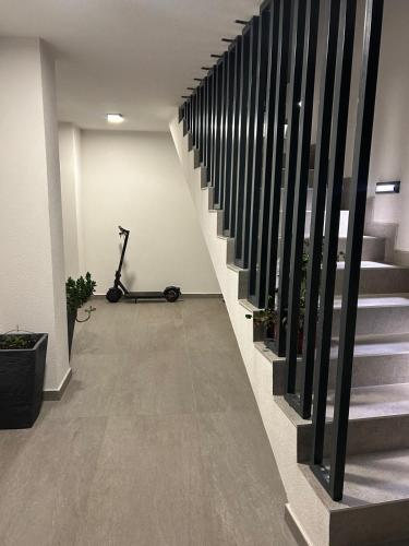 a hallway with stairs and a treadmill in a building at Apartman Pervan Large in Čapljina