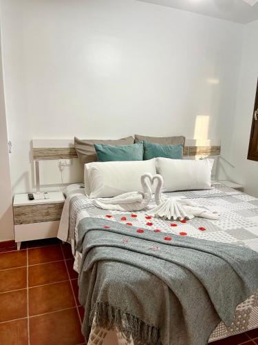 a bedroom with a bed with red hearts on it at Ruidera Resort in Ruidera