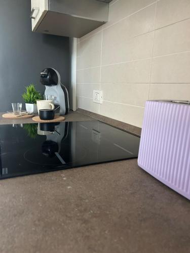 a kitchen with a counter with a coffee maker on it at La Casetta di Tommi in Sandra