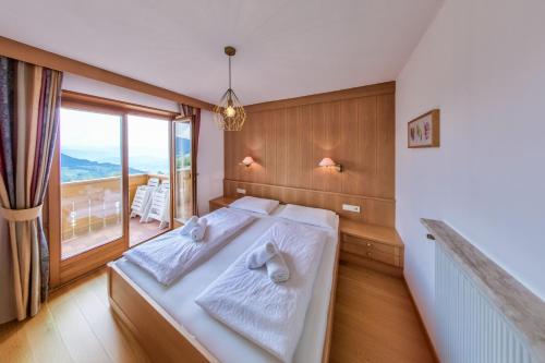 a bedroom with a bed and a large window at Wohnung Mölten in Meltina