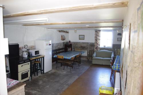 a kitchen and living room with a table and chairs at Hillside Farm in Carlisle