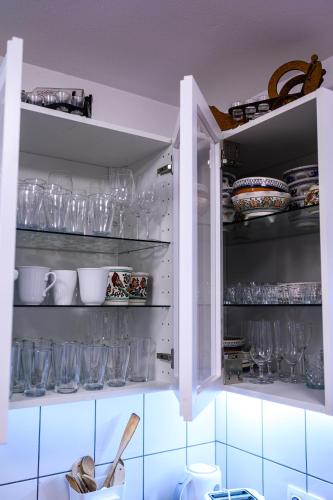 a cupboard filled with lots of glasses at Luca-lak in Izvoare