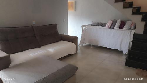 a living room with a couch and a table at Meu Aconchego próximo da cidade in Itamonte
