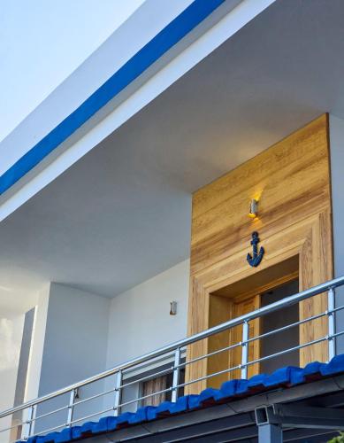 a front door of a building with a blue cross on it at La Marine Tabarka in Tabarka