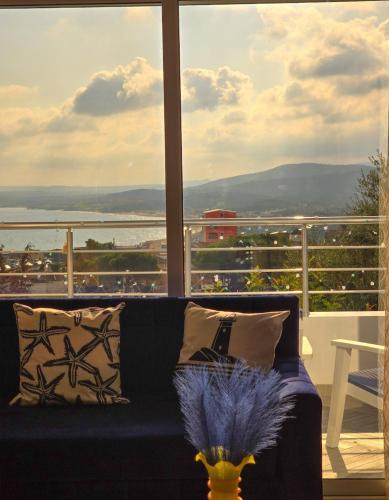 a living room with a couch and a large window at La Marine Tabarka in Tabarka