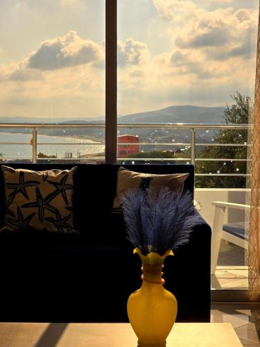 a living room with a couch and a vase on a table at La Marine Tabarka in Tabarka