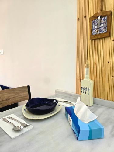 a table with a plate and a bowl on it at La Marine Tabarka in Tabarka