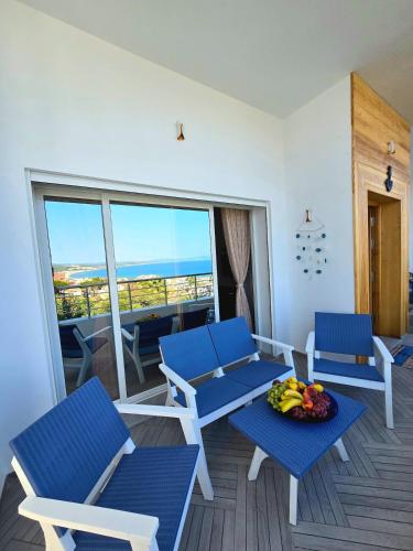 a room with blue chairs and a table with fruit on it at La Marine Tabarka in Tabarka