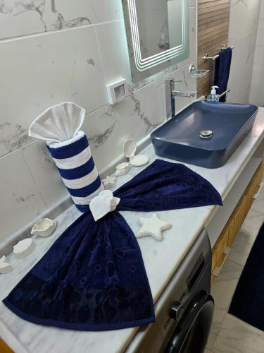 a bathroom counter with a blue and white sink at La Marine Tabarka in Tabarka