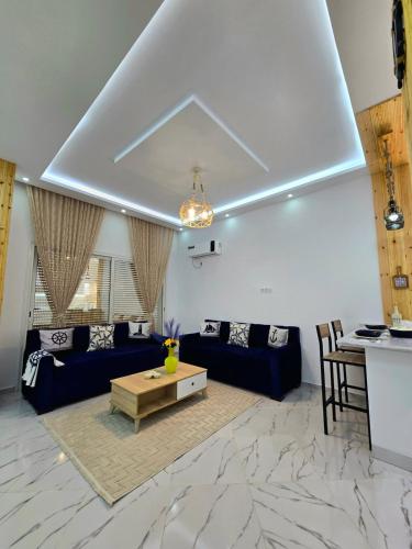 a living room with blue couches and a table at La Marine Tabarka in Tabarka