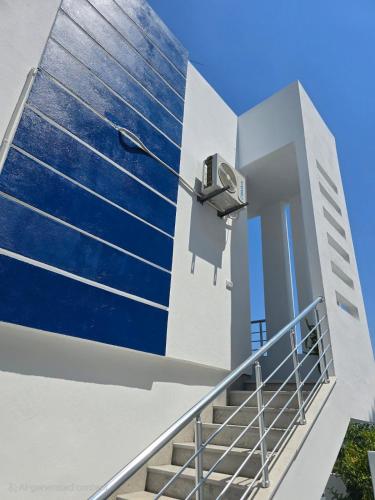 a building with stairs and a camera on the side at La Marine Tabarka in Tabarka
