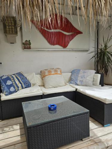a living room with two couches and a table at Nice Life appartments in Willemstad
