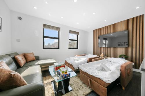 a living room with two beds and a couch at Skyline Studios Tower Bridge in London
