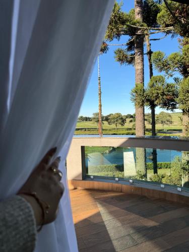 a woman is looking out the window of a wedding veil at Lagoa Parque Hotel in Lagoa Vermelha
