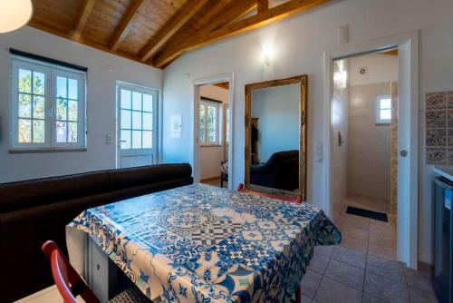 a room with a bed and a couch and a mirror at One Bedroom Chalet with private bathroom and kitchen in Alcobaça