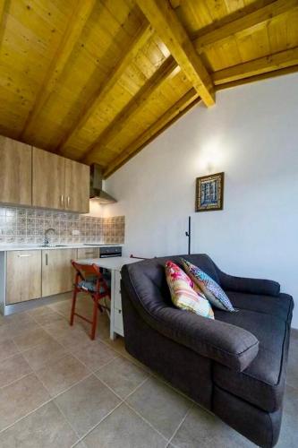 a living room with a couch and a table at One Bedroom Chalet with private bathroom and kitchen in Alcobaça