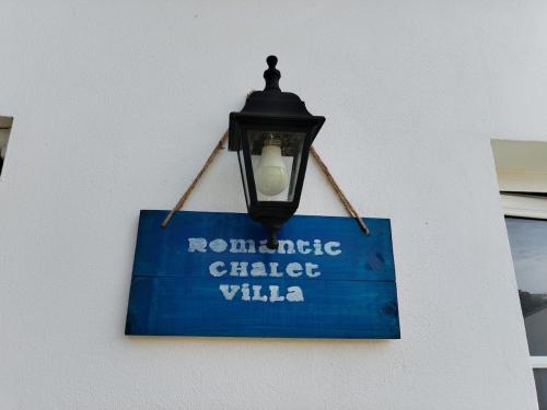 a street light with a sign on a building at One Bedroom Chalet with private bathroom and kitchen in Alcobaça
