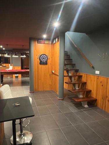 a staircase in a room with a desk and a table at Villa Ouro Verde in Gondomar