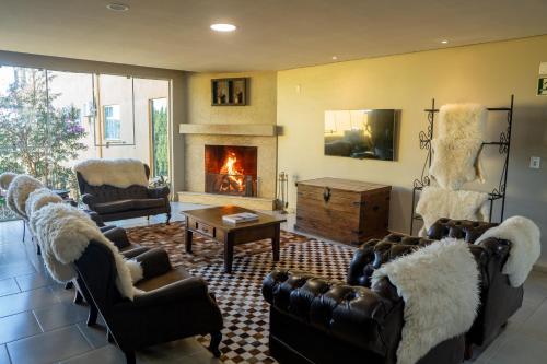 a living room with couches and a fireplace at Lagoa Parque Hotel in Lagoa Vermelha