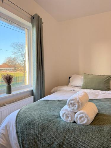 a bedroom with a bed with towels on it at Grey haven - Central & 5 min from Southmead Hospital in Bristol
