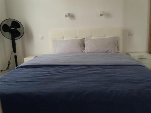 a bedroom with a blue bed with a white headboard at Tuneras Sunset Puerto Rico Apartment in Mogán