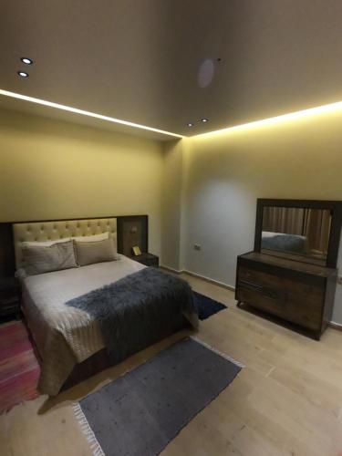 a bedroom with a large bed and a mirror at villa vue sur mer avec piscine in Al Houara