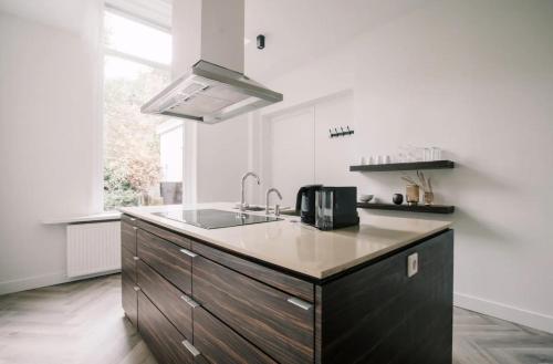 a kitchen with a sink and a counter top at Stylish city center villa tilburg in Tilburg