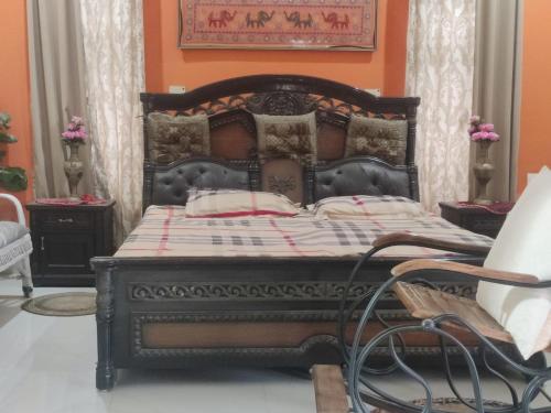 a bed in a room with an orange wall at Green Meadows Homestay in Kakarmatha