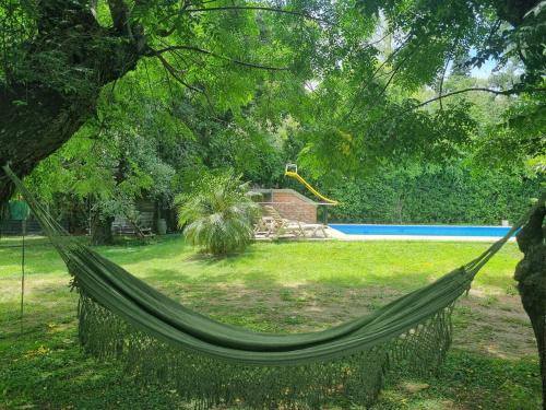 a hammock in the middle of a yard with a pool at Quinta Benavidez in Benavídez