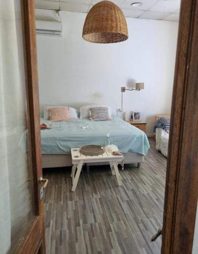 a bedroom with a bed and a table in front of it at Quinta Benavidez in Benavídez