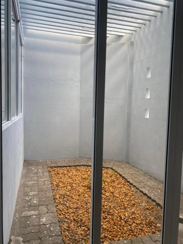 a room with a window with a pile of leaves at holiday home srilanka in Piliyandala
