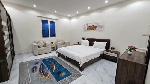 a bedroom with a bed and a living room at شاليه لارا in Rayyis