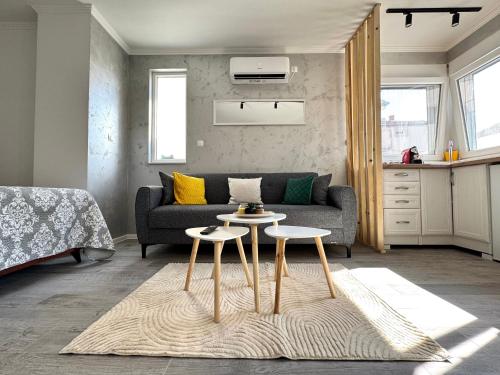 a living room with a couch and two tables at Apartment 'Avlija' in Mostar