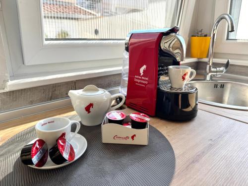 a counter with two cups and a coffee maker at Apartment 'Avlija' in Mostar