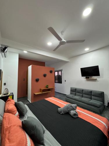 a living room with a large bed and a couch at Houzze Plety in Brisas de Zicatela