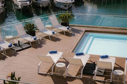 a deck with chairs and a swimming pool at Cugo Gran Macina Malta in Senglea