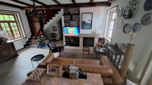 a living room with a couch and a television at Casa de Cardido in Guimarães