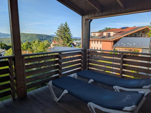 a balcony with two chairs and a view of the mountains at Ferienhaus Enzo in Oberaichwald