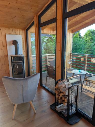 a living room with a chair and a wood stove at Ferienhaus Enzo in Oberaichwald