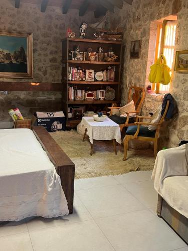 a room with two beds and a table and chairs at Nils Home in Dhërmi
